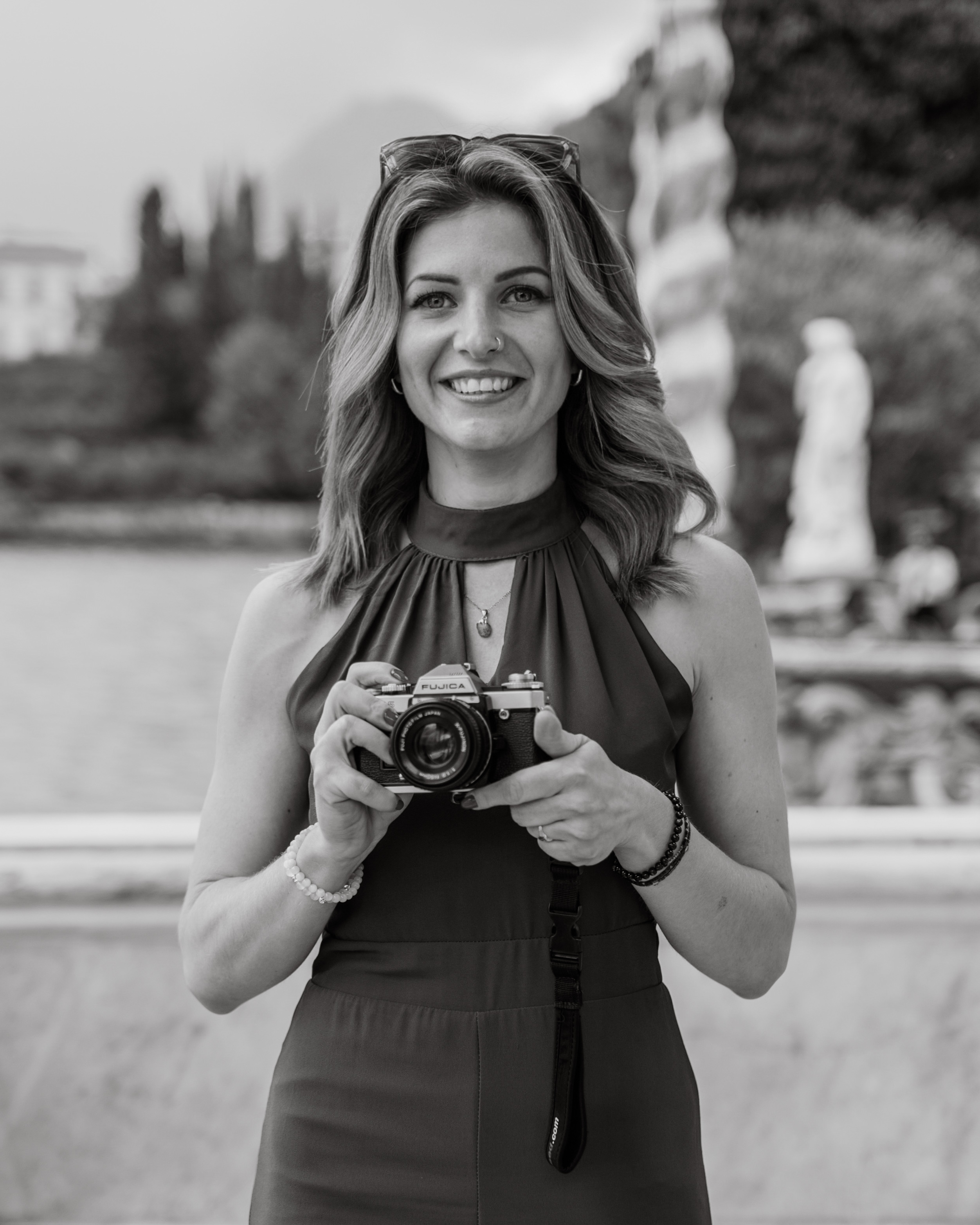 Alexandra holding a camera outdoors